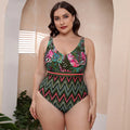 Women's striped vest one-piece swimsuit with spaghetti straps and floral print on blue background.