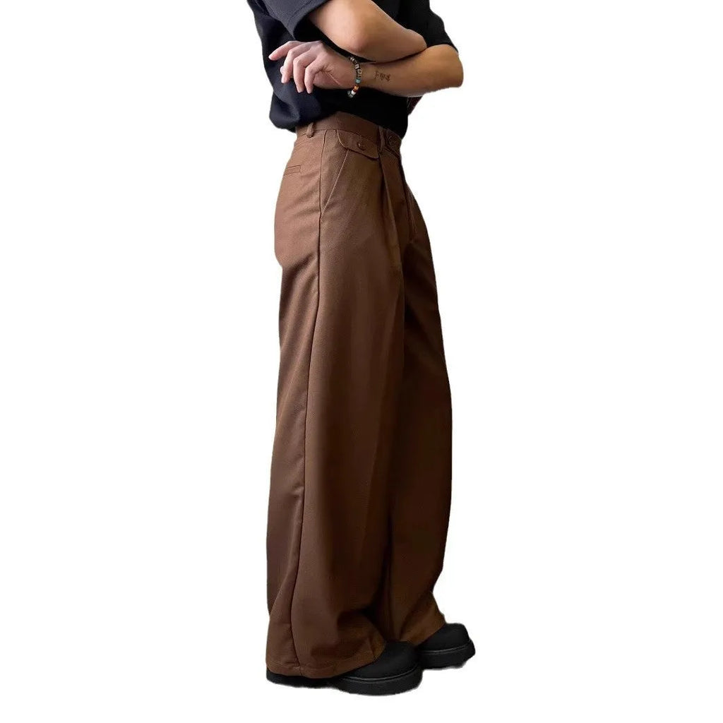 Men's loose-fitting straight-leg trousers in brown and black colours on a hanger
