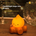 Small cartoon silicone fire pile night lamp with yellow glow on a surface