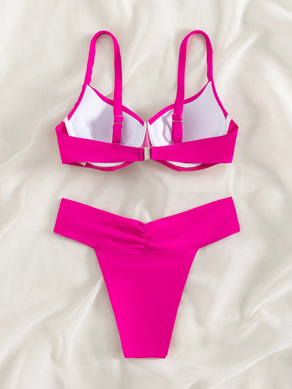 Solid colour bikini swimsuit on a mannequin, showing the sleeveless bra and briefs in a fluorescent hue.