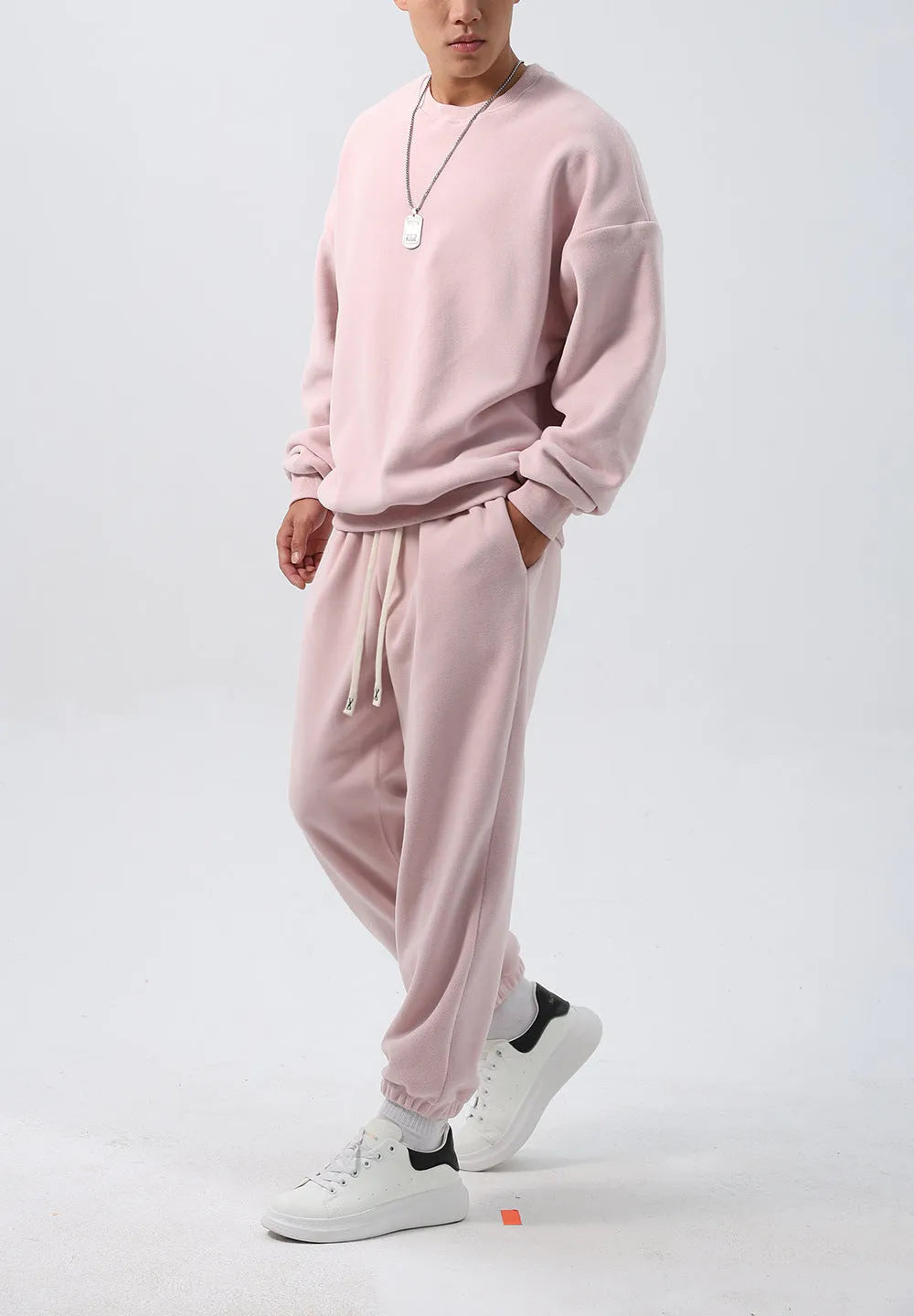 Men's black polar fleece sports suit with crew neck coat and padded trousers on a hanger