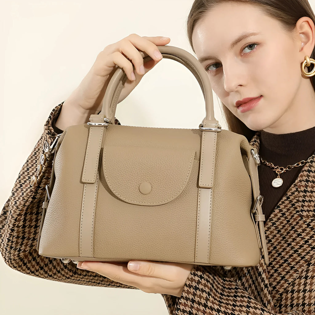 Genuine leather ladies shoulder bag in street trend style with lock detail and contrast stitching.