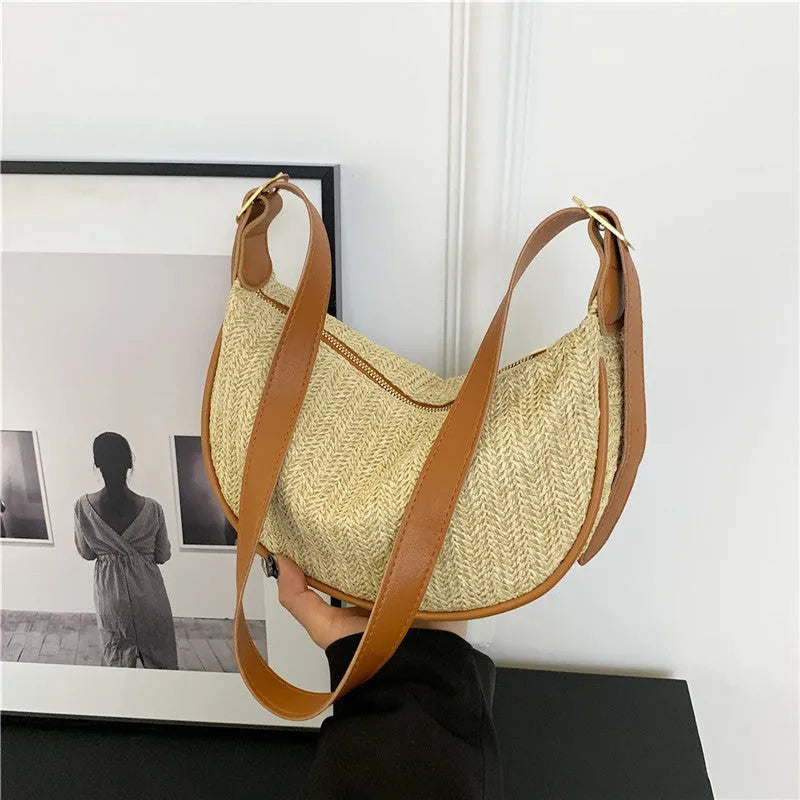 Women's knitted straw woven crossbody bag showing woven texture and internal phone/document compartments