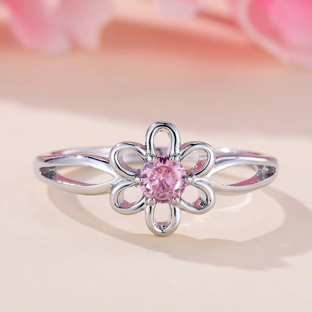 Women's flower hollow fashion ring in copper with electroplated metallic finish