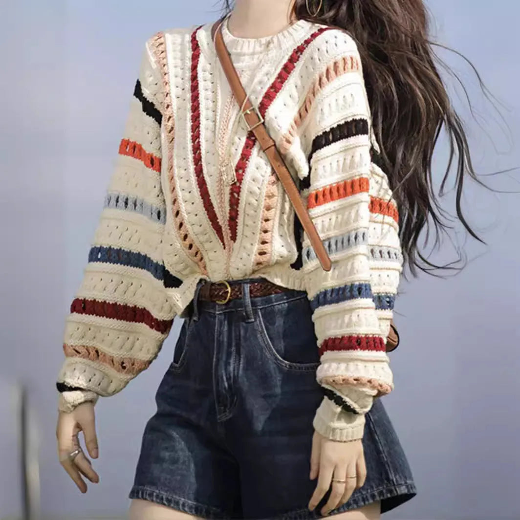 Round neck pullover sweater with rainbow stripes in hollow knit design featuring batwing sleeves