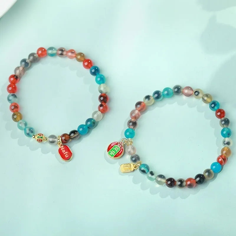 Women's agate snake bracelet with copper coin detailing and coloured glaze accents in geometric design