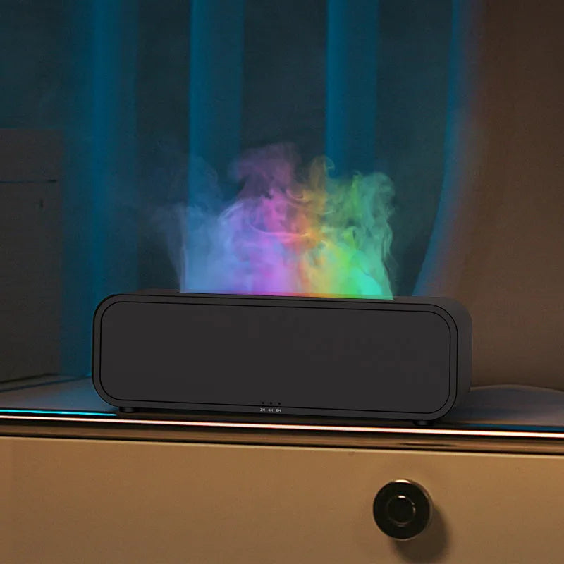 Black aromatherapy diffuser with colour-changing lights and remote control on table
