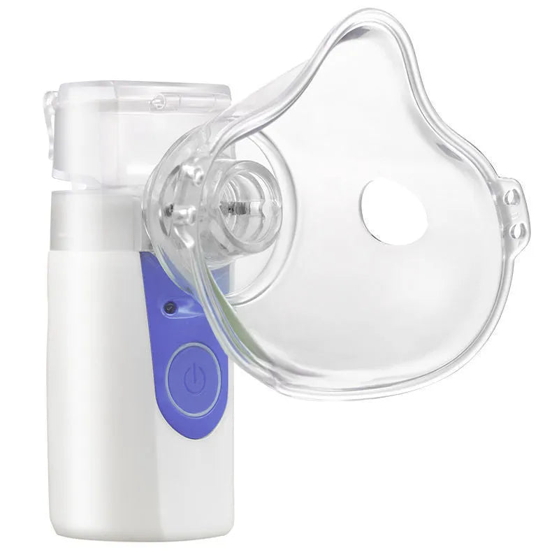 White columnar plastic USB handheld nebuliser spray machine with water tank on a table.