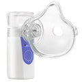 White columnar plastic USB handheld nebuliser spray machine with water tank on a table.