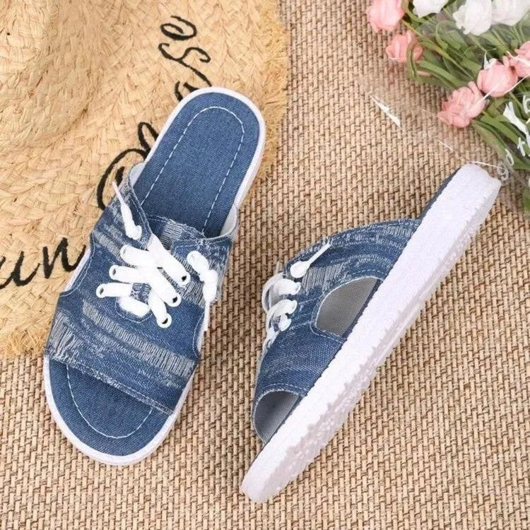 Blue Roman style women's canvas slippers with rubber sole and cloth lining displayed flat