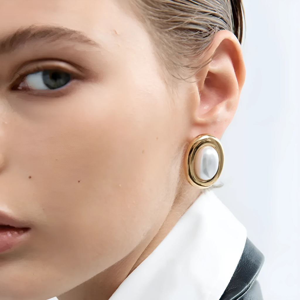 A pair of stainless steel vintage pearl stud earrings with an electroplated silver-coloured finish.