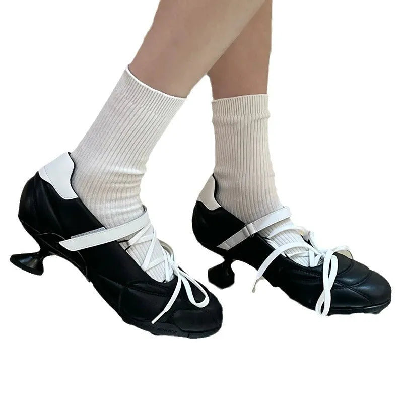 Women's silver lace-up bow sports shoes with round toe and mid-heel on a white background.