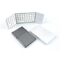 Mini tri-fold Bluetooth keyboard in black showing unfolded typing surface and thin profile