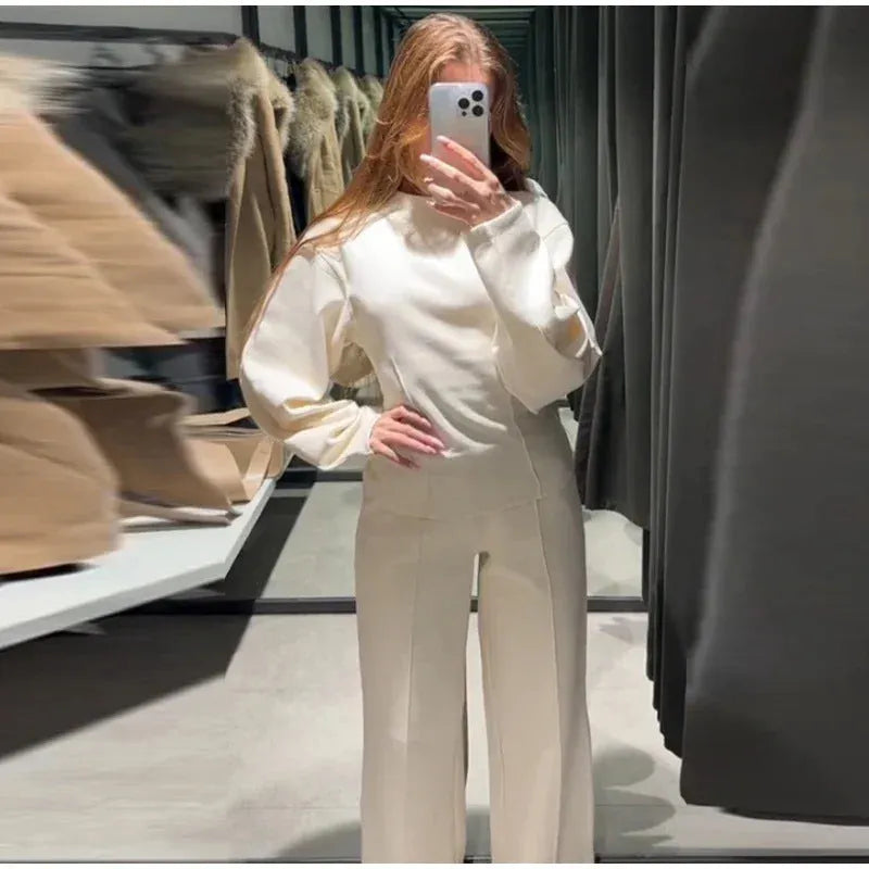 Women's black polar fleece long sleeve pleated top and wide leg trousers suit set.