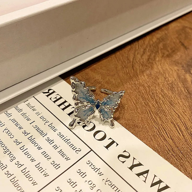Copper butterfly women's ring with drip oil finish in an open-loop design.