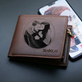 Men's brown leather wallet with a silver zipper closure, showing open view of multiple card slots.