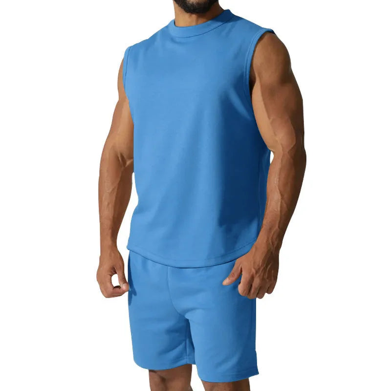 Man wearing a sleeveless army green top and matching shorts from a casual cotton blend sports suit set.