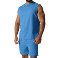 Man wearing a sleeveless army green top and matching shorts from a casual cotton blend sports suit set.
