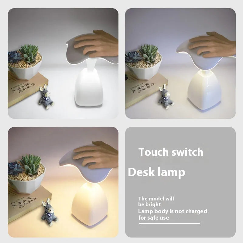 White modern LED desk lamp with a plastic shade and touch switch on a table.