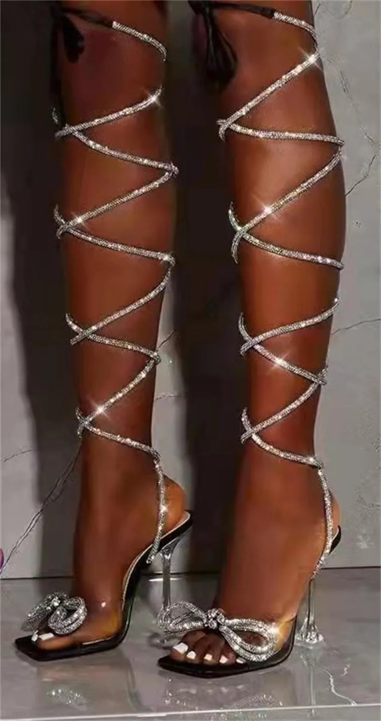 Plus size women's black strappy sandals with rhinestone decorations on Roman-style straps and a square toe.