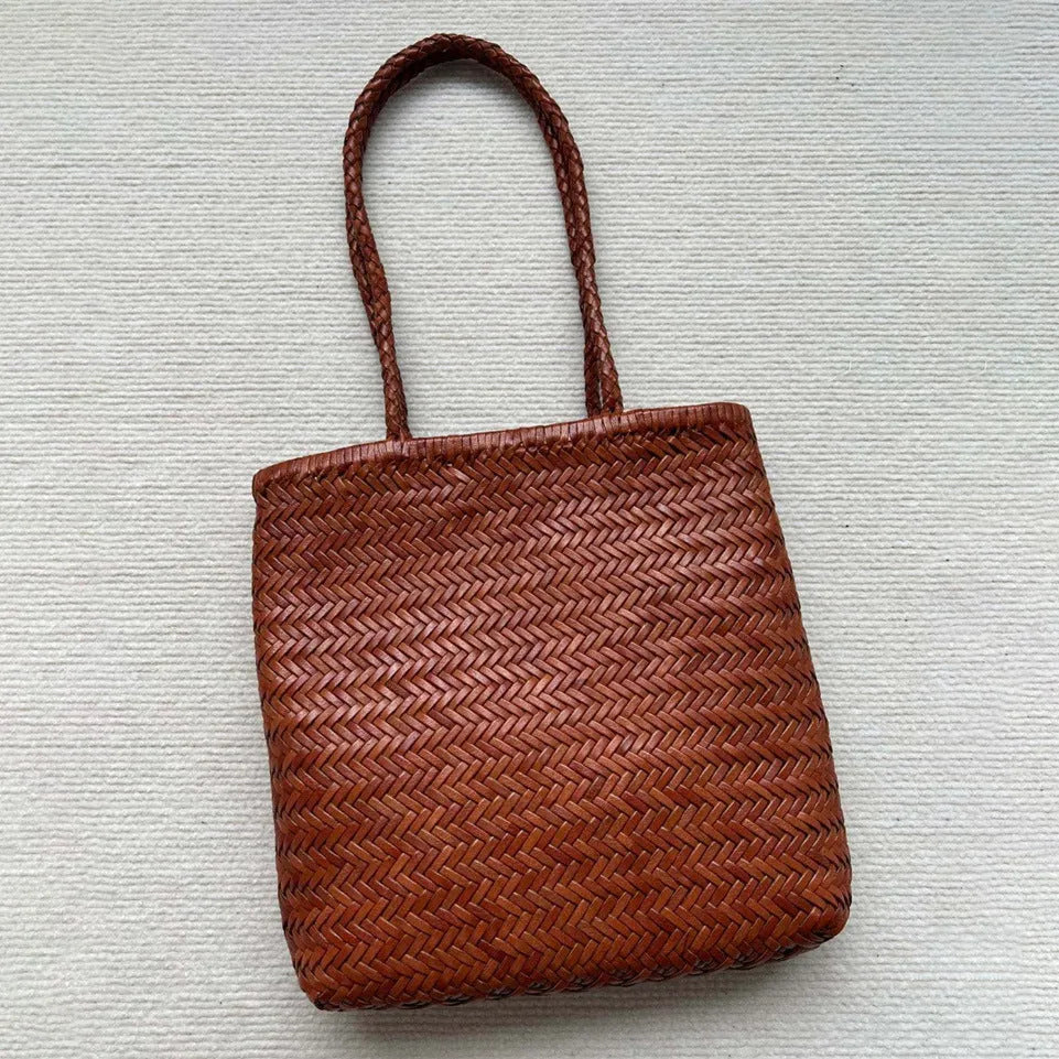 Brown handmade woven tote bag with three-dimensional pocket design and cowhide leather construction