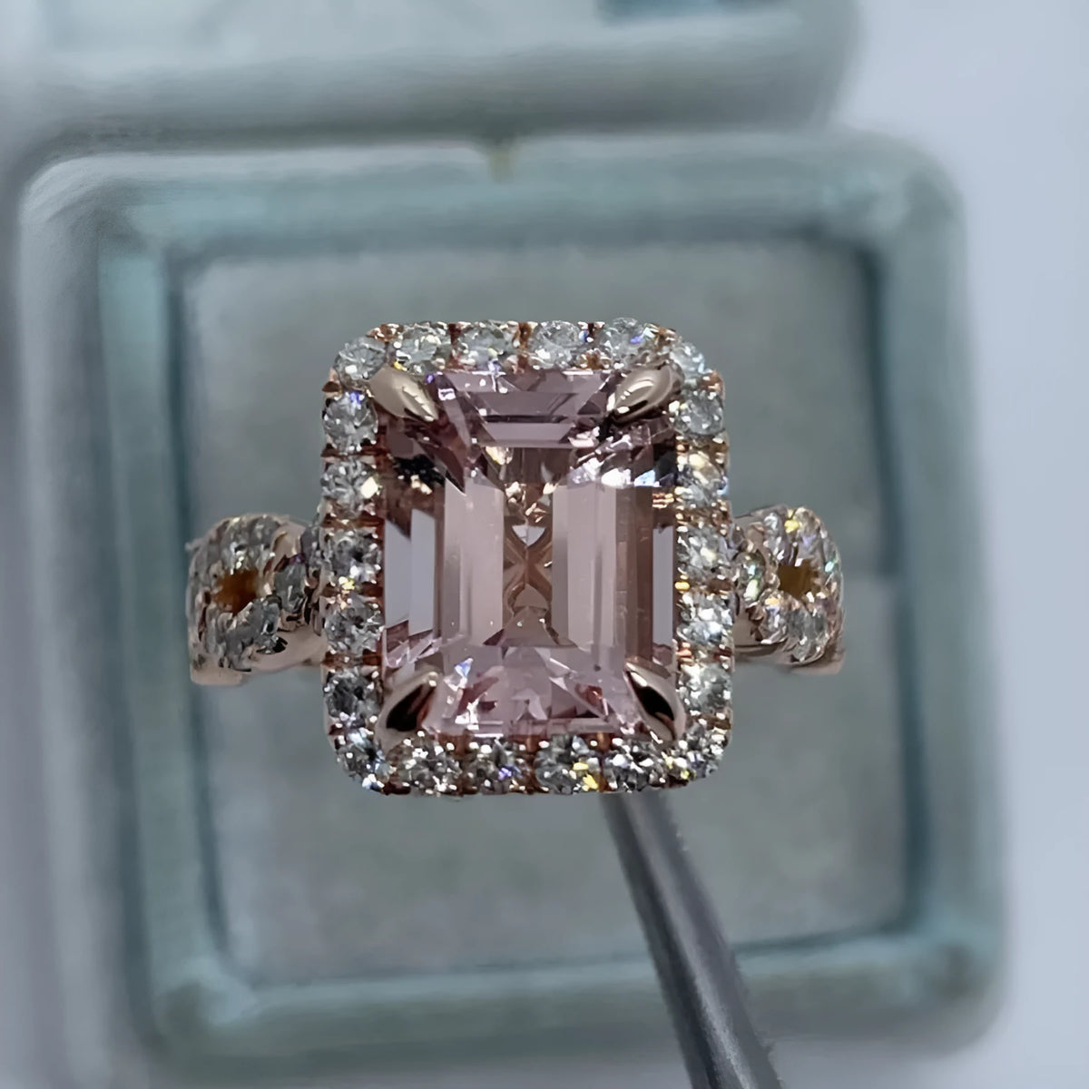 Geometric rose gold coloured alloy ring on a plain background.
