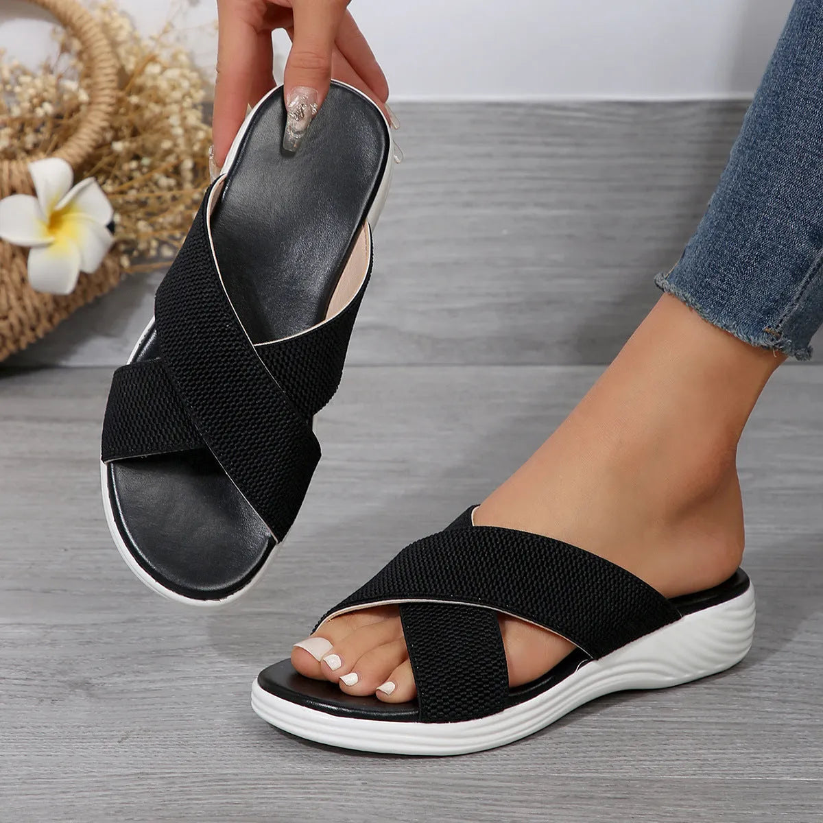 Women's black peep-toe wedge slippers with thick rubber sole showing fish mouth scaffold design