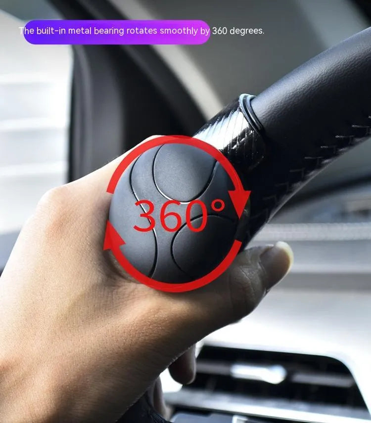 Black steering wheel assist ball with silicone grip and metal bearing mechanism for one-handed vehicle control