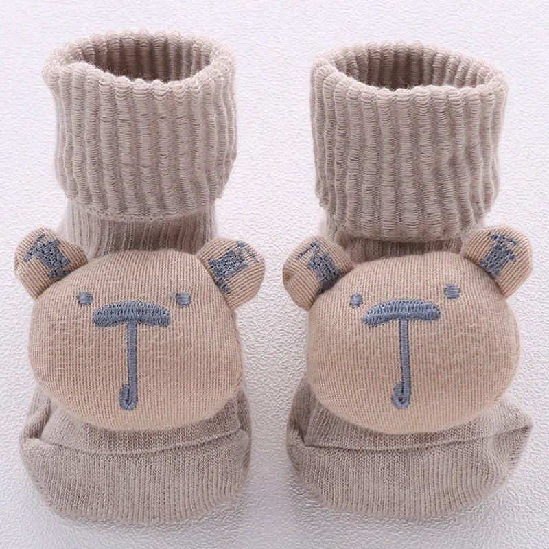 Cotton baby floor socks in a selection of colours and patterns like panda, lion, and bows, shown in sizes for infants.