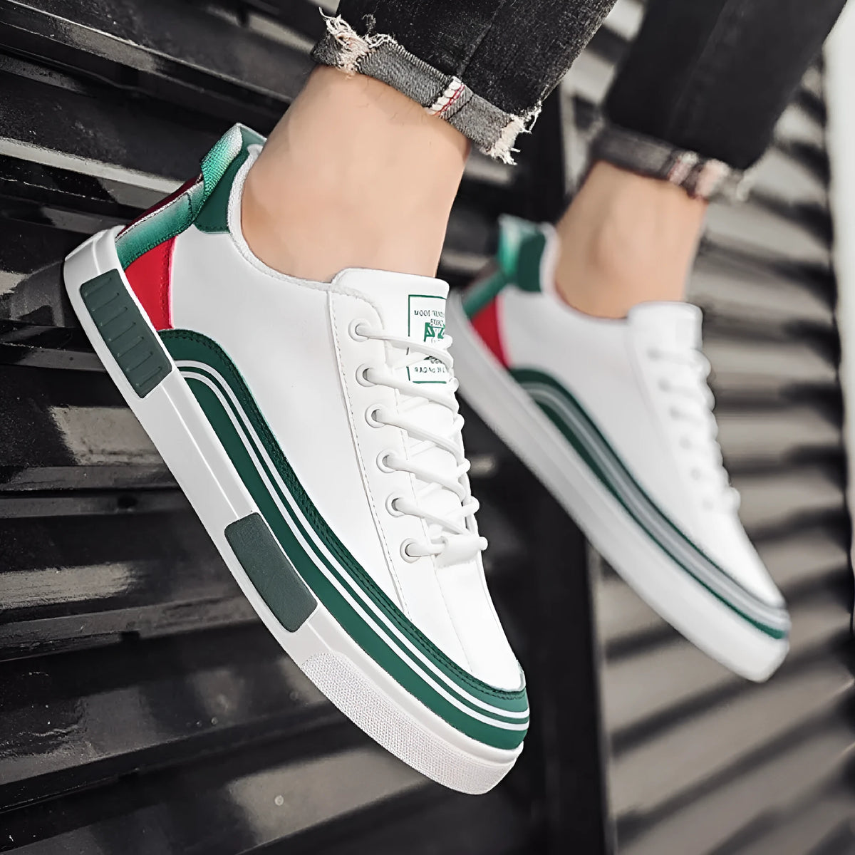 Men's white and green canvas casual shoes with visible mesh panel sections on a flat heel.