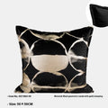 Black gold abstract pattern decorative cushion with removable cover in three size options on a sofa.