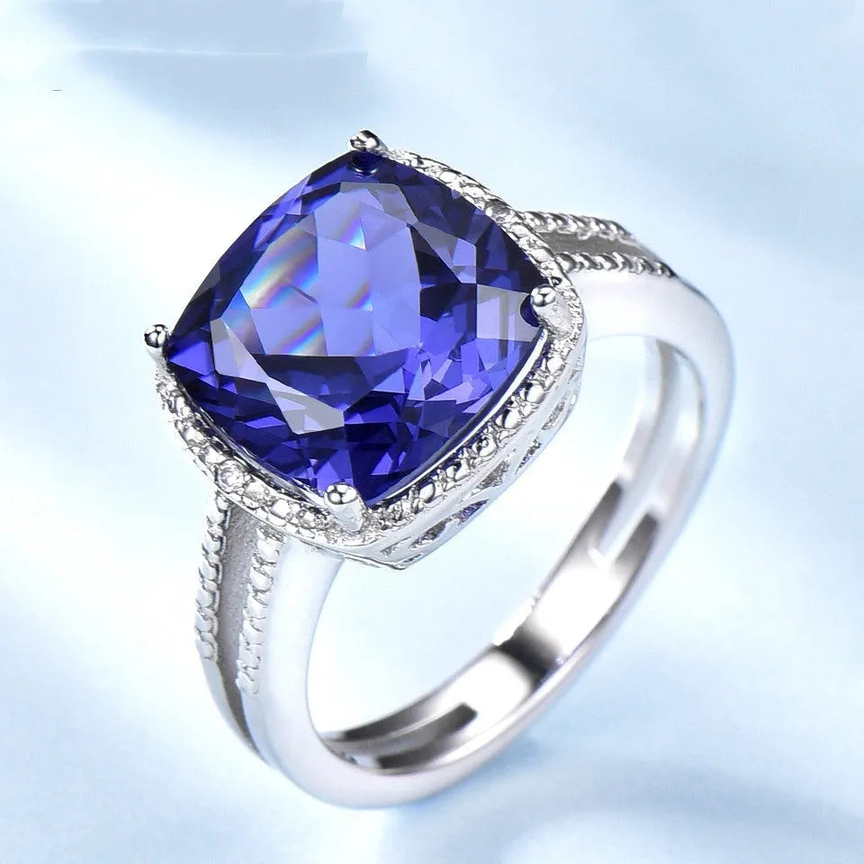Blue tanzanite stone set in a sterling silver women's ring, shown in size 8.