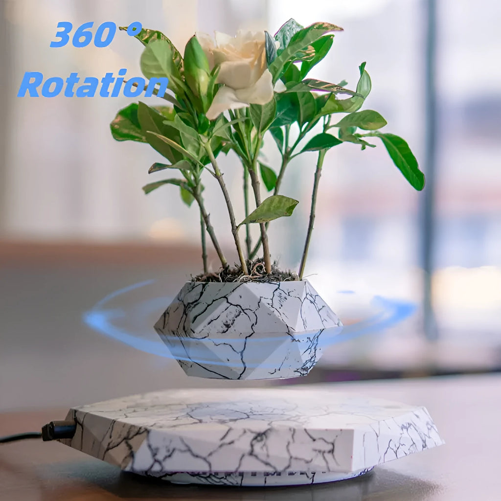 Marble-coloured magnetic levitating plant pot floating above surface with small plant