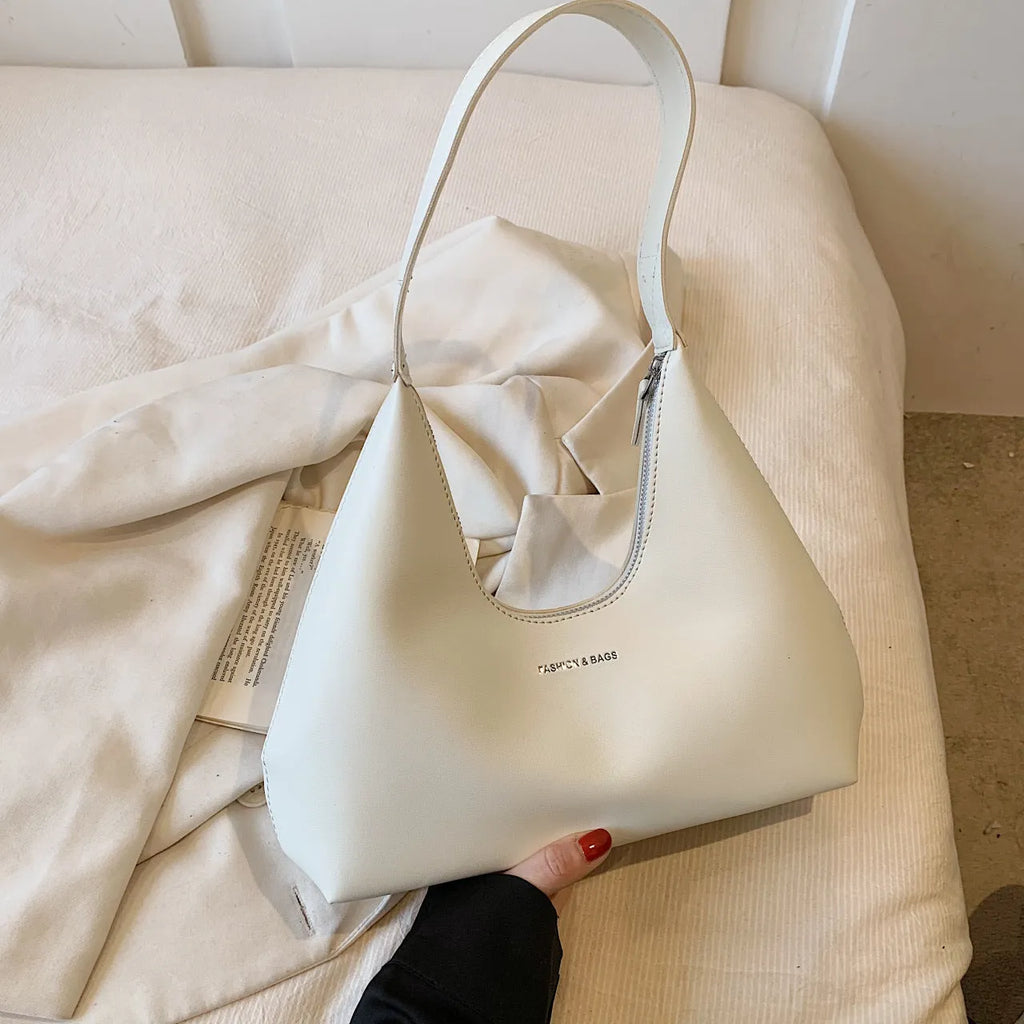 Brown retro PU leather shoulder handbag with a single strap, pillow shape, and stitching detail.