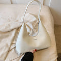 Brown retro PU leather shoulder handbag with a single strap, pillow shape, and stitching detail.