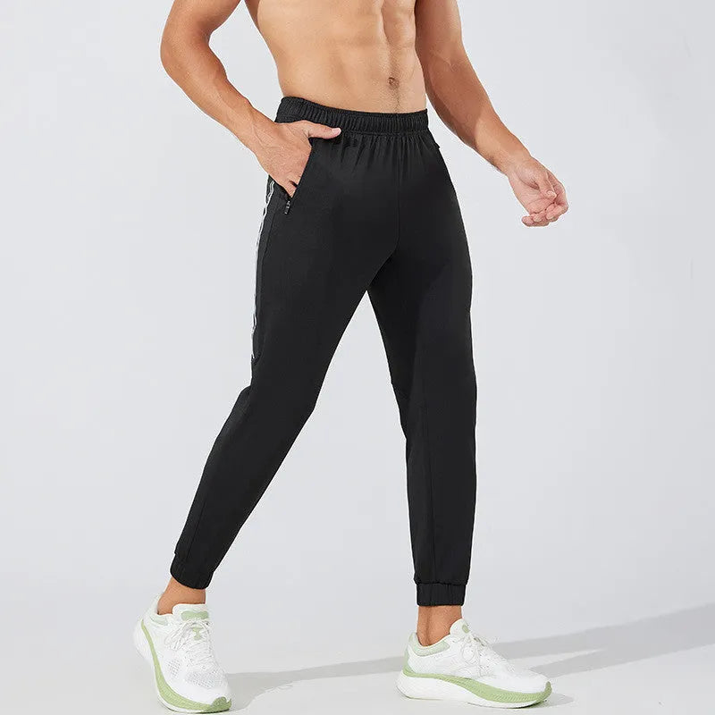 Men's black and navy blue running trousers with mid waist design and polyester fabric
