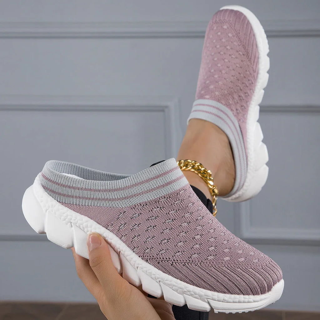 Women's black flyknit slippers with hollowed-out pattern and a height-increasing viscose sole.