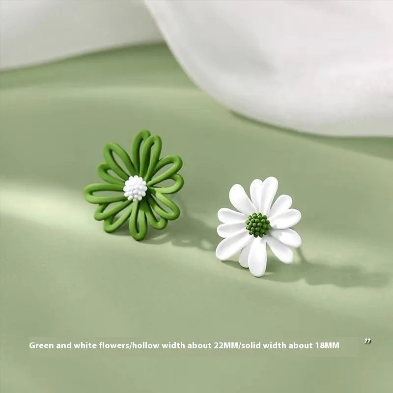 Close-up of cartoon-style flower stud earrings in alloy, shown in blue and orange two-tone colour combination.