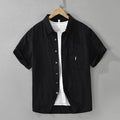 Loose-fit short-sleeve cardigan top in lyocell fabric, shown in black colour.