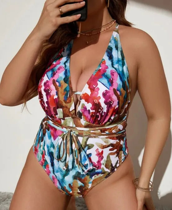 Adult woman wearing a solid blue one-piece halter swimsuit with a bikini-style design.