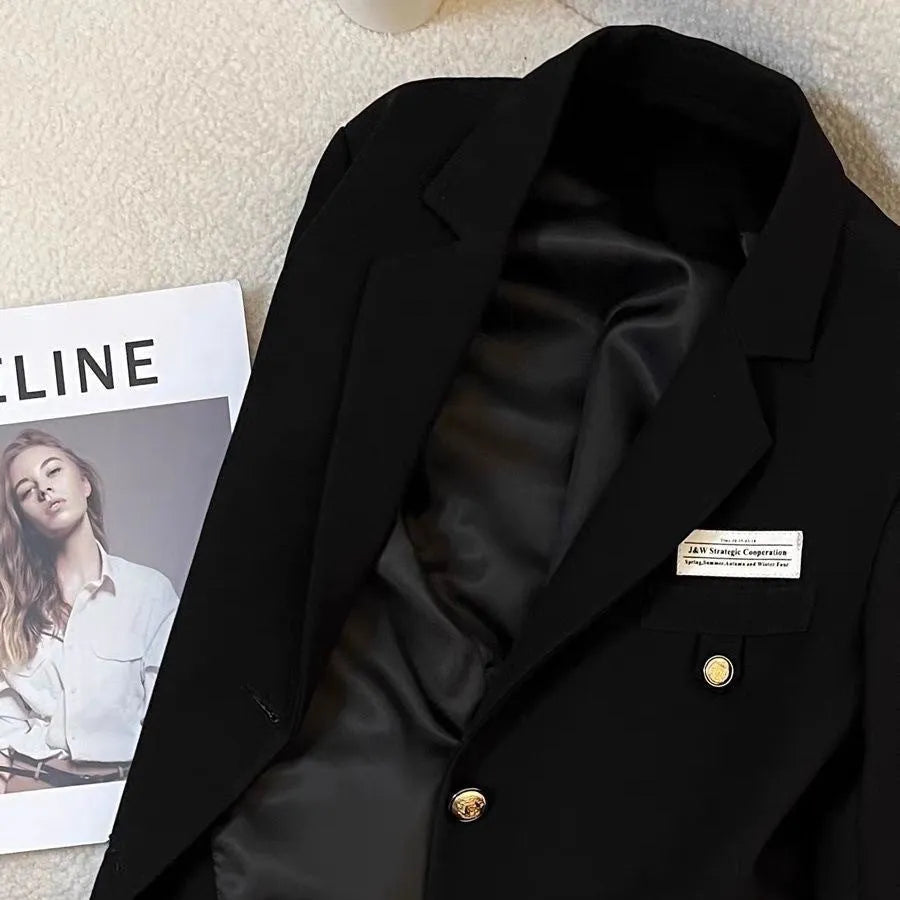 Black women's short suit coat with regular sleeves and pocket details