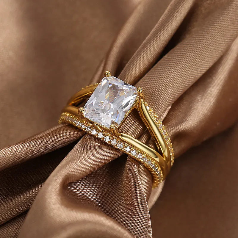 Gold square zircon geometric ring on finger showing electroplated copper construction