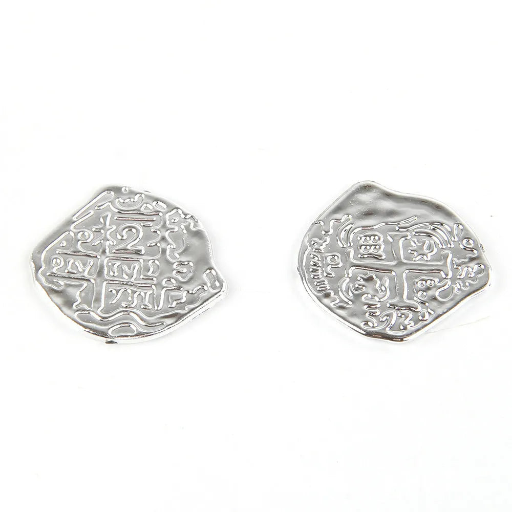 A pile of plastic Roman coins with a metallic gold finish, part of a 100-piece set for treasure-themed parties.