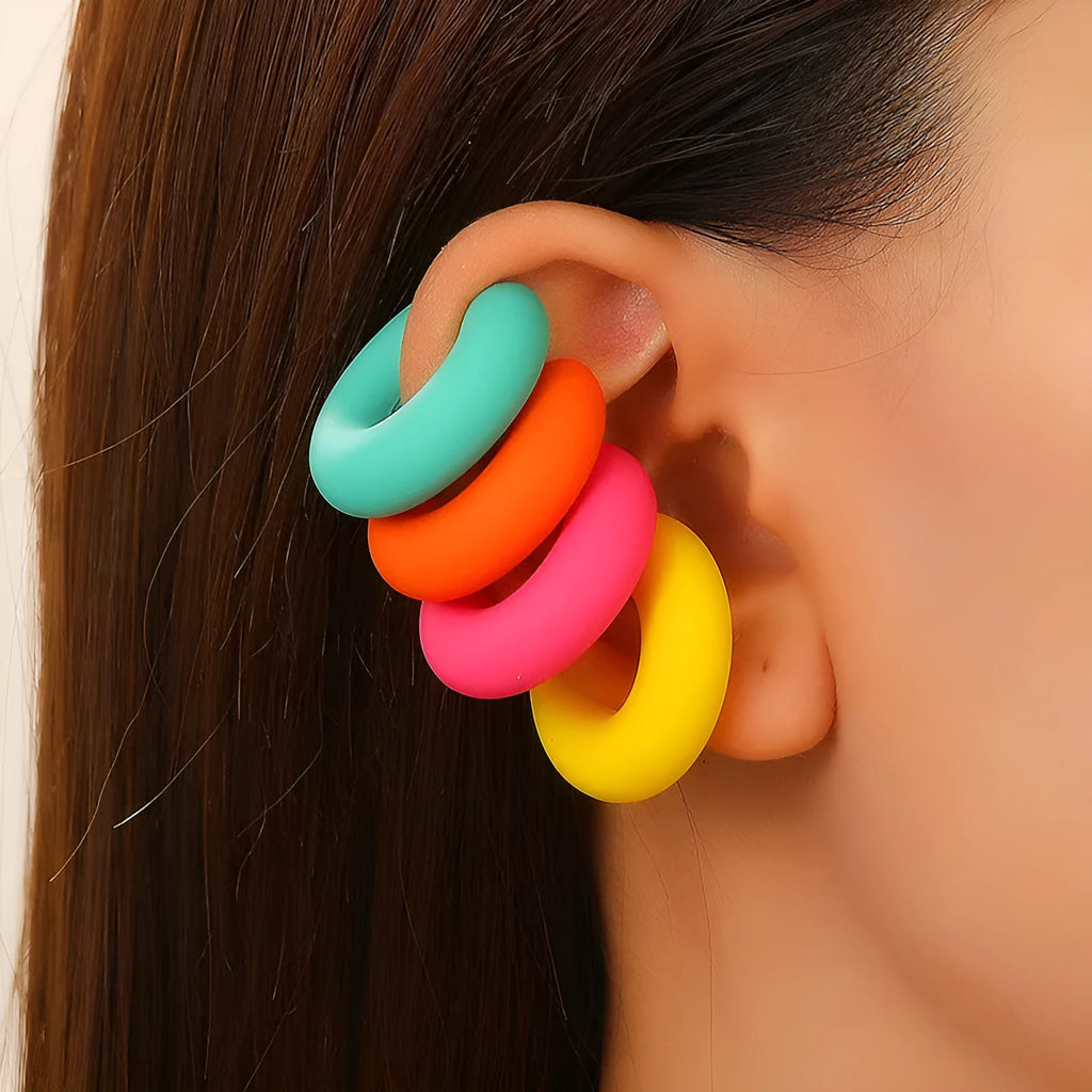 Geometric C-shaped matte clip-on earrings in multiple candy colours on a white background.