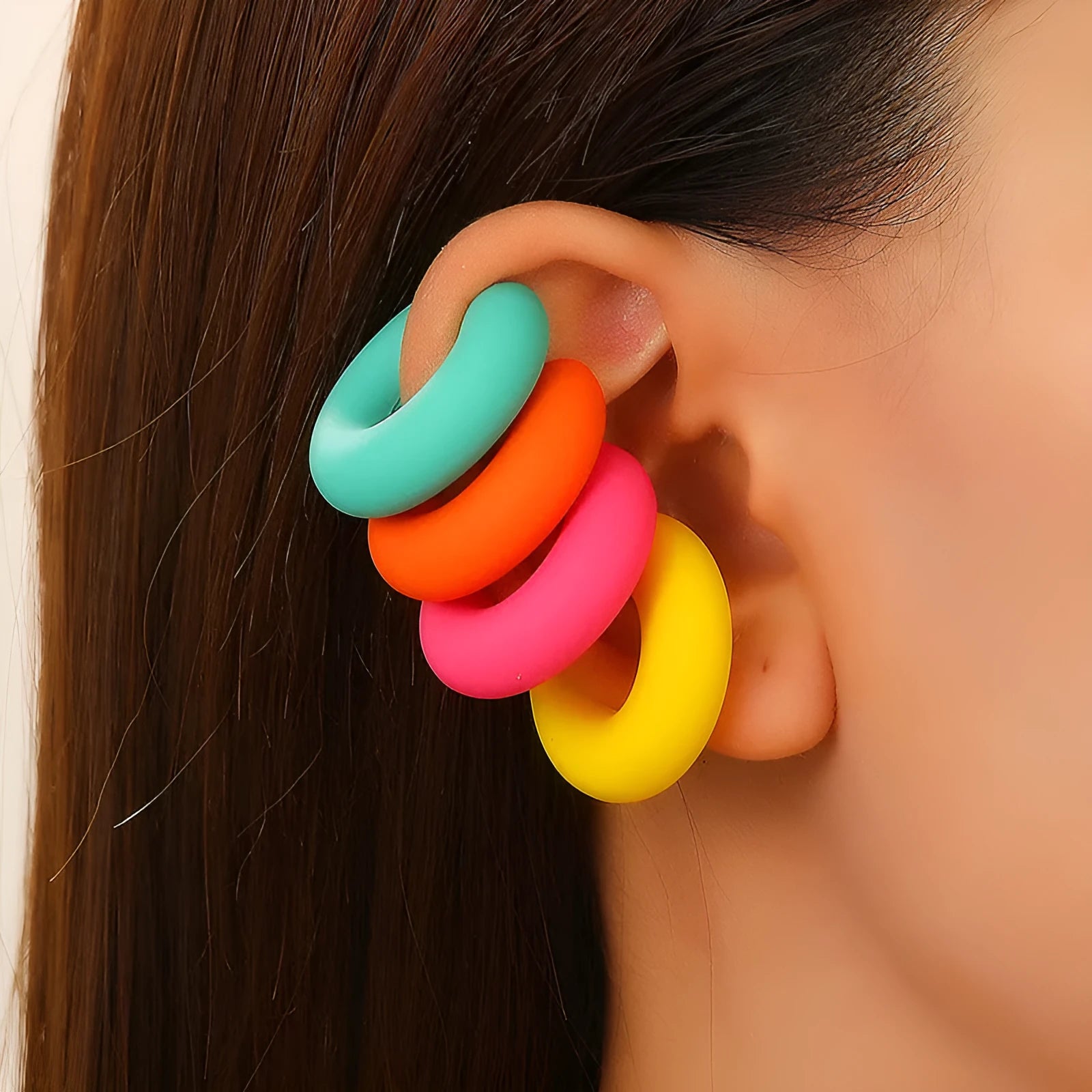 Geometric C-shaped matte clip-on earrings in multiple candy colours on a white background.