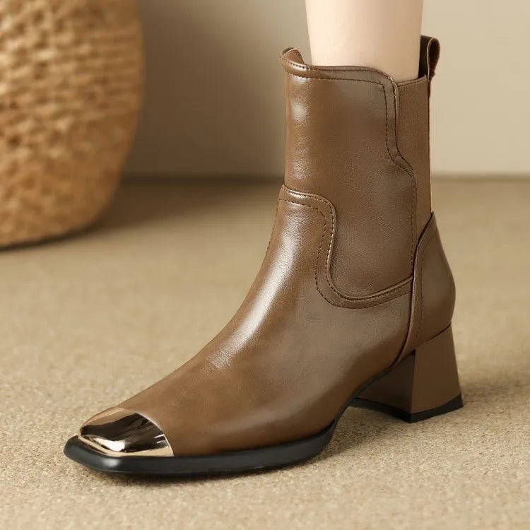 Women's brown cowhide Martin boots with high heel and side zipper, featuring decorative metal elements