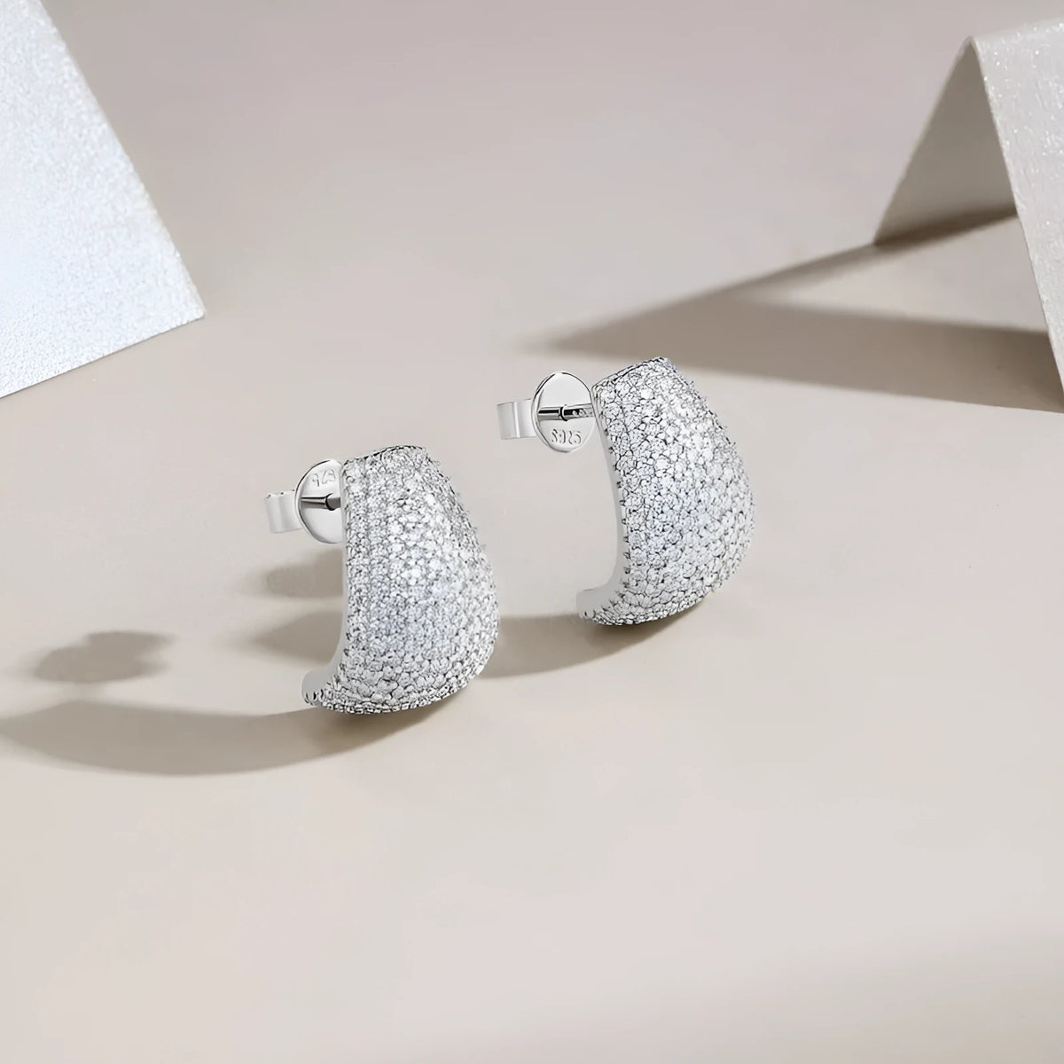 Geometric women's ear studs in sterling silver with white moissanite stones.