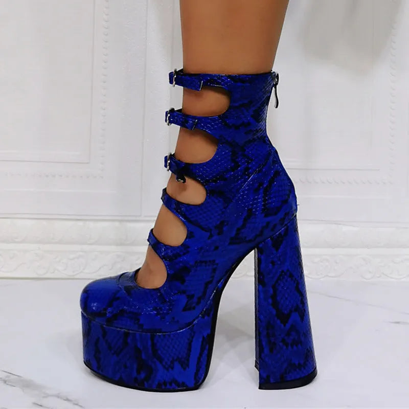 Women's black patent leather platform high heels with a thick serpentine ankle strap and buckle fastening.