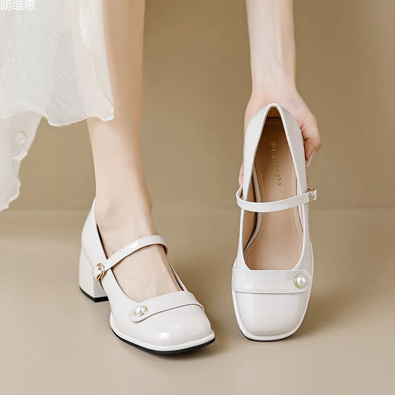 Women's apricot patent leather chunky heel pumps with a buckle fastening and square toe.