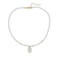 White necklace with a mother of pearl conch shell pendant and beads on an electroplated chain.